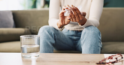 Buy stock photo Person, hands and pills with water on sofa for prescription, medication or side effects at home. Closeup, patient or user with pharmaceuticals tablets for illness, symptoms or virus on couch at house