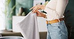 Woman, hands and fold laundry in home for domestic chores, housekeeping task or sanitary hygiene. Housewife, person or packing clothes in basket for cleaning service, housework routine or cleanliness