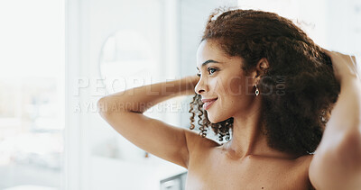 Buy stock photo African woman, happy and hair care by bathroom mirror with smile for grooming, growth and volume in home. Person, morning and afro with routine for hairstyle, results and curly texture at apartment