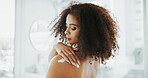 African woman, lotion and shoulder in home, bathroom and moisturizer application for skin wellness. Person, cream and product with vitamin e, results and benefits with self care routine at apartment
