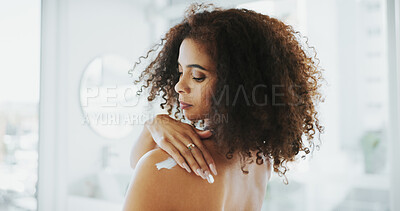 Buy stock photo African woman, lotion and shoulder in home, bathroom and moisturizer application for skin wellness. Person, cream and product with vitamin E, results and benefits with self care routine at apartment