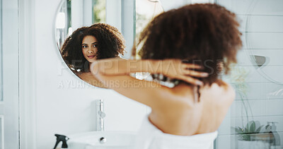 Buy stock photo Woman, afro and hair care by mirror with smile for grooming, growth and volume in bathroom at house. African person, reflection and happy for routine for hairstyle, results and curly texture in home