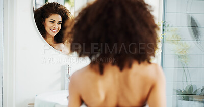 Buy stock photo Woman, afro and happy by mirror with hair care for check, growth and volume in bathroom at house. African person, reflection and morning routine for hairstyle, results and curly texture in home
