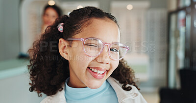 Buy stock photo Portrait, kid or happy customer with glasses at store for optometry, eyewear or wink at shop. Female child, frames and playful girl with smile or spectacles for sight, vision or choice at optometrist