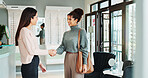 Woman, handshake and greeting with optometrist at store for eyecare, sight or vision at optometry. Female person, shaking hands and optician with smile for assistance or advice on glasses at shop