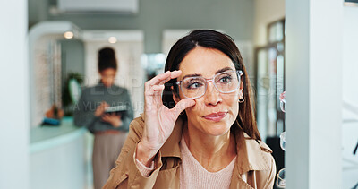 Buy stock photo Eye care, woman and glasses choice in mirror for frame shopping, prescription lens size and eyewear fitting. Mature person, eyesight and check for vision correction and optical health in retail store