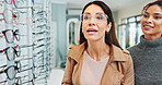 Woman, vision and sight with advice at optometrist for glasses, shopping or customer service at store. Female person, lens or spectacles with optician help for eyecare, eyewear or optical assistance