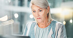 Business, serious and woman with laptop, reading and planning for company growth, online and bokeh. Corporate, entrepreneur and mature person with tech, thinking and ideas for investment in office