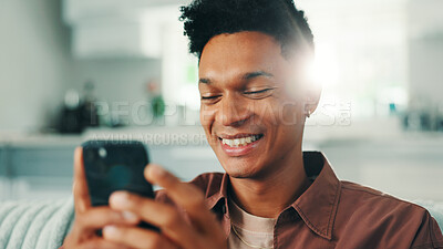 Buy stock photo Dating app, phone and man laughing in home on social media application and texting on weekend. Chilling, funny meme or happy person with mobile message on sofa for comedy post, chat or online website