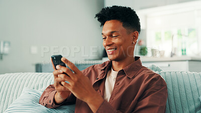 Buy stock photo Online dating, phone and man texting in home on social media application and subscription on weekend. Sign up, technology or male person with mobile message on sofa for post, chat and news website