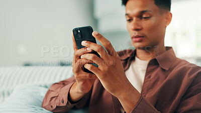 Buy stock photo Online dating, mobile and man texting in house on social media application and subscription on weekend. Sign up, technology or male person with phone message on sofa for post, chat and news website