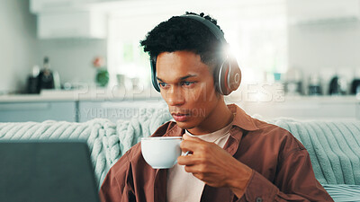 Buy stock photo Coffee, headphones and laptop with man on sofa in living room of home for time off or weekend streaming. Computer, morning and relax with person drinking fresh caffeine beverage from cup in apartment