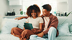 Tablet, relax and couple in living room in home with planning romantic vacation, holiday or getaway. Happy, digital technology and man with woman for booking flights for honeymoon trip in apartment.