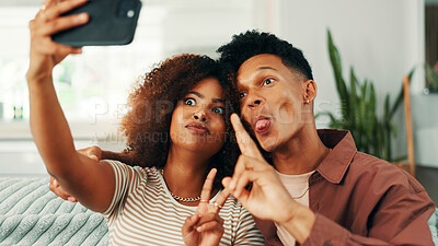 Buy stock photo Funny, peace sign and selfie with couple on sofa in home living room together for memory. Bonding, love or photograph and happy people with tongue out in apartment for social media or profile picture