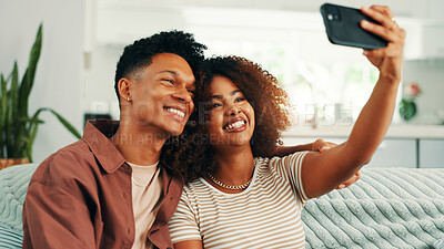 Buy stock photo App, selfie and smile with couple on sofa in living room of home together for memories. Bonding, love and relax with people in apartment for photograph, profile picture or social media update