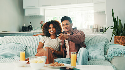 Buy stock photo Couple, watching tv and remote at home with movies, series and browsing online. Man, woman and living room sofa for bonding, press play or snacks with subscription package for entertainment in house