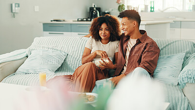 Buy stock photo Couple, watching tv and popcorn at home with movies, series and affection. Man, woman and living room sofa for bonding, streaming online or snacks with subscription package for entertainment in house