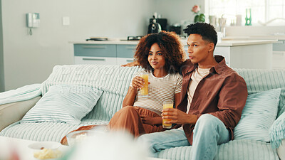 Buy stock photo Couple, juice or watching tv to relax on sofa for romance, love and bonding together in home. Drinks, subscription or man on couch with woman or care for streaming film, television or series in house