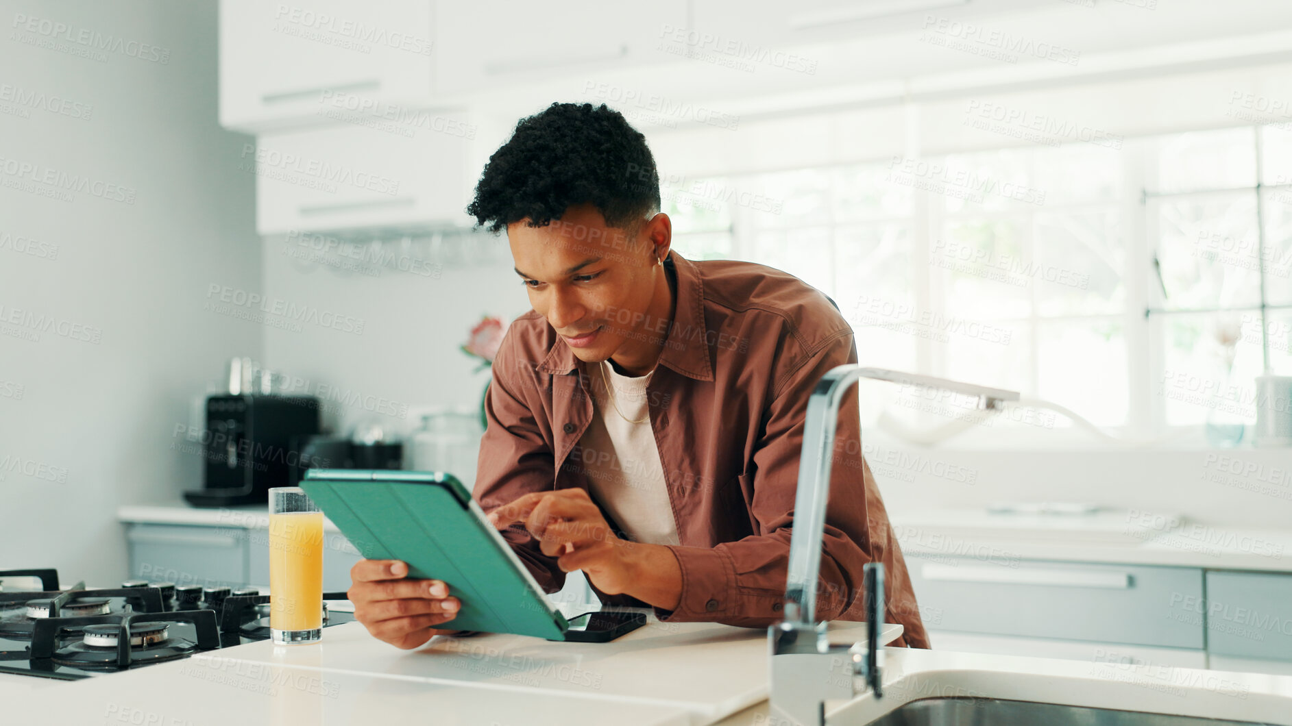 Buy stock photo Man, happy and tablet in kitchen, home and search for recipe, video and learning with subscription. Person, digital touchscreen and application for online course, smile and cooking lessons at house