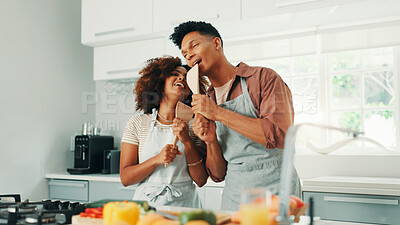 Buy stock photo Love, cooking and couple with singing in kitchen for dinner preparation, anniversary celebration and bonding. Relax, people and spoon mic for romantic karaoke date, healthy meal and marriage support