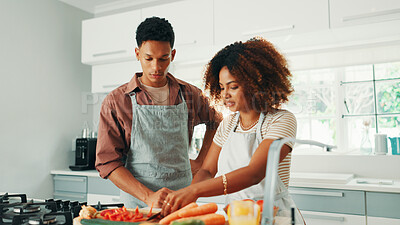 Buy stock photo Cooking, learning and couple in kitchen in home for nutrition, wellness or healthy dinner together. Vegetables, bonding and man helping woman for preparing diet meal for supper in apartment.