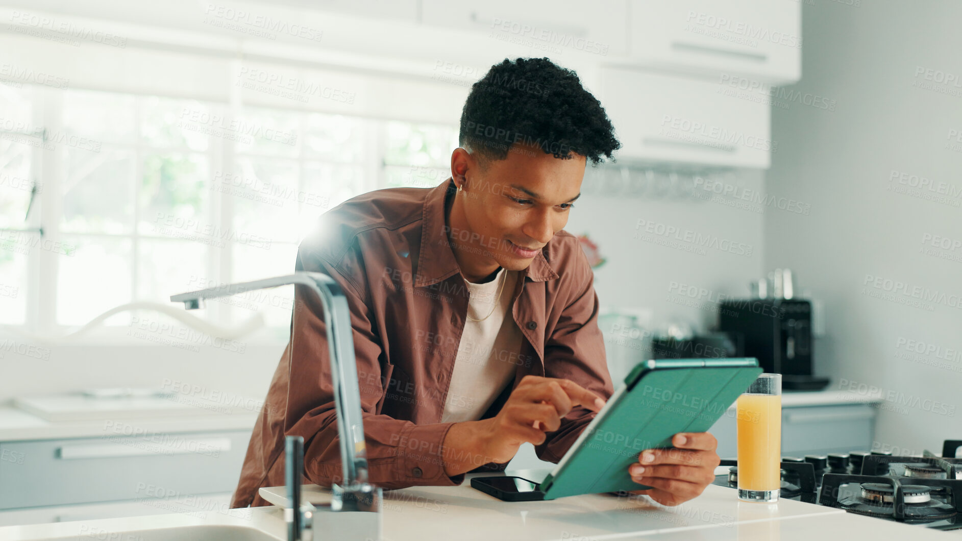 Buy stock photo Man, smile and tablet in kitchen, home and search for recipe, video and learning with subscription. Person, digital touchscreen and application for online course, happy and cooking lessons at house