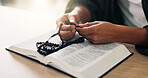 Bible, hands and person reading book with rosary in spiritual religion for peace, guidance and learning. Beads, house or worship with praise, scripture and gratitude with prayer, faith and gospel