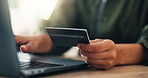 Hands, person or credit card with laptop in home for online shopping, banking payment or typing voucher code. Ecommerce, closeup and fintech on technology for website transaction or discount purchase