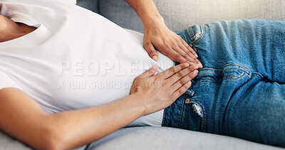 Buy stock photo Woman, lying or hands on stomach with pain, menstruation cramps or IBS symptoms in home. Person, discomfort or sofa with period, tummy ache or bloating with celiac complication in living room