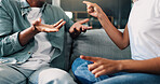 Couple, hands and fight in home with stress, infidelity and pointing for accusation. People, argument and gesture on sofa with conflict tension, disagreement and angry in toxic relationship for blame