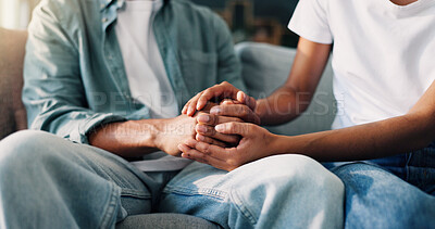 Buy stock photo Couple, holding hands and relax in home for support, consoling and trust in relationship. People, lovers and gesture on living room sofa with empathy, commitment and connection for mental health
