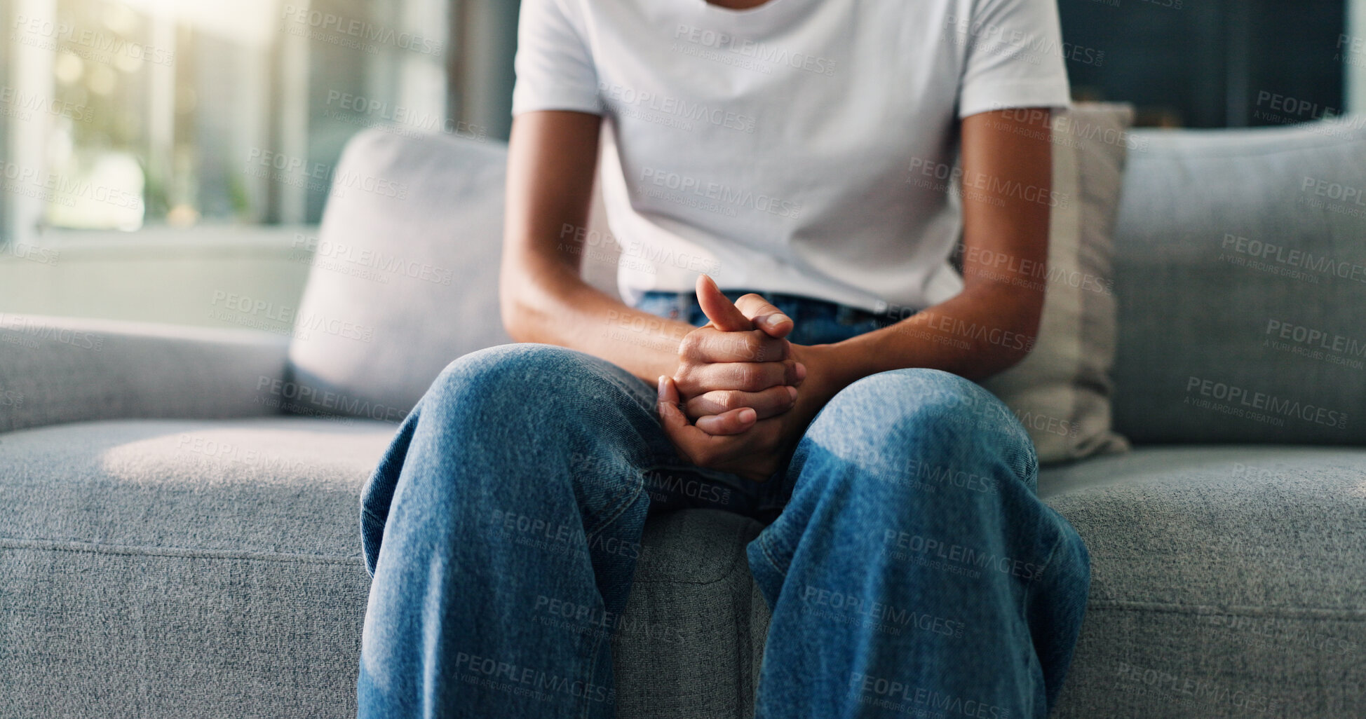 Buy stock photo Hands together, psychology and person on sofa, anxiety and stress with depression. Trauma, therapy room and client on couch, counselling and mental health with worry, nervous and consultation