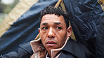 Homeless, poverty and thinking with man in park for depression, unemployment rate and winter crisis. Mental health risk, refugee and welfare aid with male person in tent for tired, poor and worry
