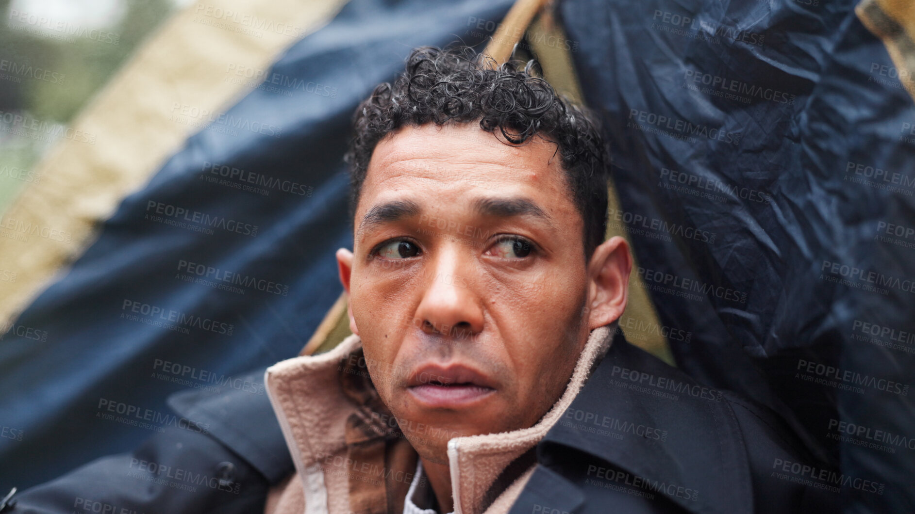 Buy stock photo Homeless, poverty and thinking with man in park for depression, unemployment rate and winter crisis. Mental health risk, refugee and welfare aid with male person in tent for tired, poor and worry