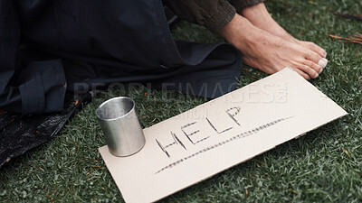 Buy stock photo Person, homeless and cardboard sign for help, poverty and begging for money, change and cup at park. Feet, outdoor and poster for donation, care and hungry on ground with hope for support in morning