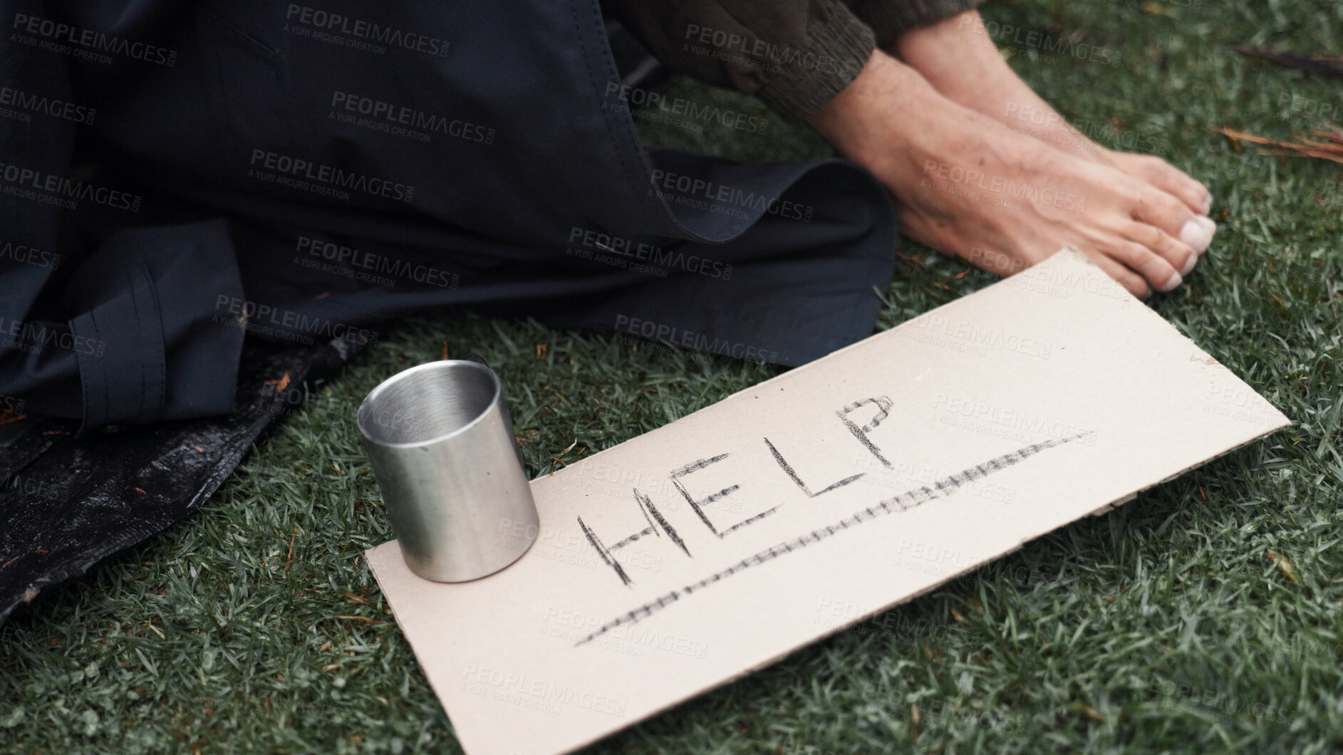 Buy stock photo Person, homeless and cardboard sign for help, poverty and begging for money, change and cup at park. Feet, outdoor and poster for donation, care and hungry on ground with hope for support in morning