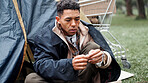 Man, poverty and homeless with drugs at park, package and thinking with illegal product by tent in winter. Person, narcotic substance and chemical for craving, crime and poor with stress in Brazil