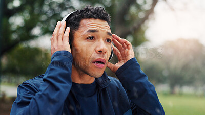Buy stock photo Fitness, man and break with headphones at park for running music, breathing and cardio challenge with sound. Runner, athlete and listening to podcast for exercise, morning jog and workout with radio