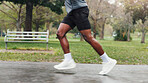 Legs, running and man with fitness, outdoor and training with wellness, exercise and speed. Closeup, person and runner in park, morning routine and hobby with health, workout and practice with shoes