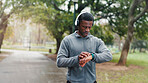 Smart watch, fitness and black man in park, check time and monitor heart with training. African person, runner and athlete with clock, track progress and exercise with challenge, outdoor and workout