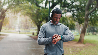 Buy stock photo Smart watch, fitness and black man in park, check time and monitor heart with training. African person, runner and athlete with clock, track progress and exercise with challenge, outdoor and workout