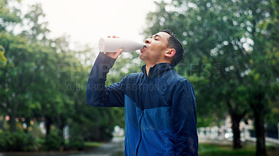 Buy stock photo Drinking water, outdoor and man with fitness, healthy guy and training with thirsty. Person, athlete and runner in street, bottle and liquid with wellness, hydration and sports with exercise