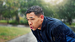 Athlete, man and tired with breathing at park for running fatigue, performance recovery and cardio challenge. Runner, person and rest in rain with fitness break, butnout and overworked with training