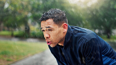 Buy stock photo Athlete, man and tired with breathing at park for running fatigue, performance recovery and cardio challenge. Runner, person and rest in rain with fitness break, burnout and overworked with training