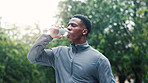 Drinking water, outdoor and black man with exercise, healthy guy and wellness with thirsty. African person, athlete and runner with bottle, break and mineral liquid with fitness, hydration and sports