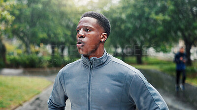 Buy stock photo Fitness, man and rest with breathing at park for marathon fatigue, running recovery or endurance challenge. Athlete, black person and tired in rain with workout break, exercise performance or burnout