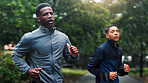 Fitness, rain and athlete running at park for marathon training, endurance or discipline with workout performance. People, teamwork and cardio with breathing exercise, sports challenge and wellness