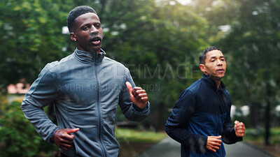 Buy stock photo Fitness, rain and athlete running at park for marathon training, endurance or discipline with workout performance. People, teamwork and cardio with morning exercise, sports challenge and wellness