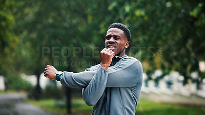 Buy stock photo Arms, fitness and man with stretching outdoor for marathon performance, muscle strength or exercise in rain. Wet, black person and warm up at park for cardio workout, competition and sports training