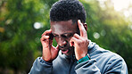 Exercise, fatigue and headache with black man outdoor in park for cardio training, marathon or running. Burnout, fitness and pain with tired athlete or runner in nature for challenge or workout
